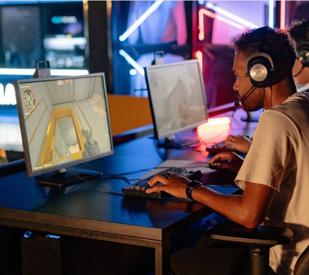 Gamers competing at PC stations under neon light